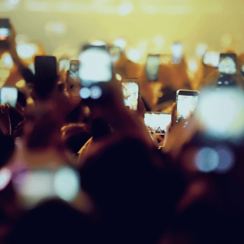 People taking photos and videos at an event