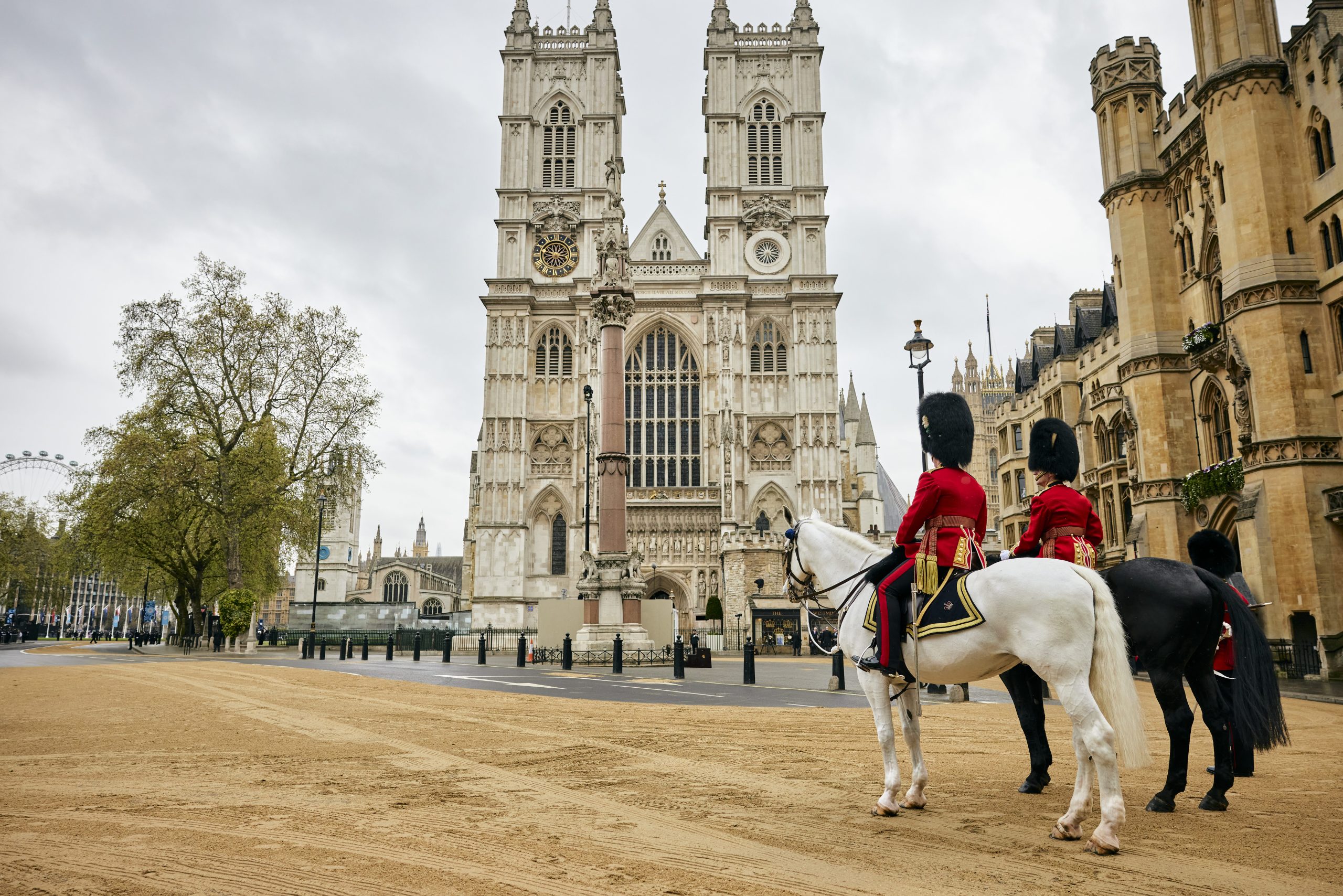 A guard on horseback in front of old buildings