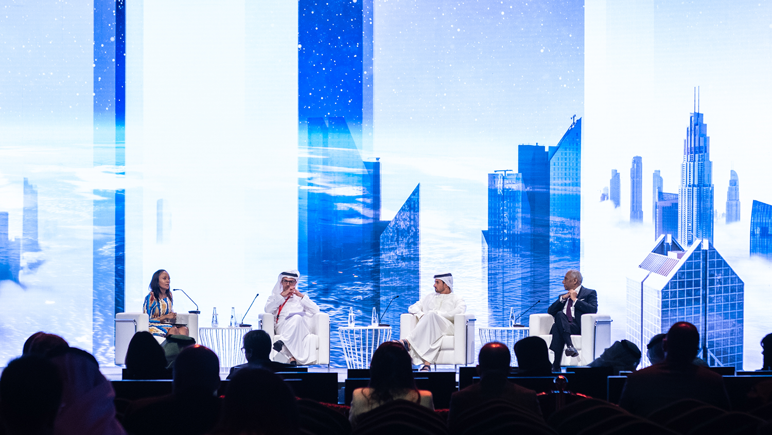 Speakers on stage at a global event