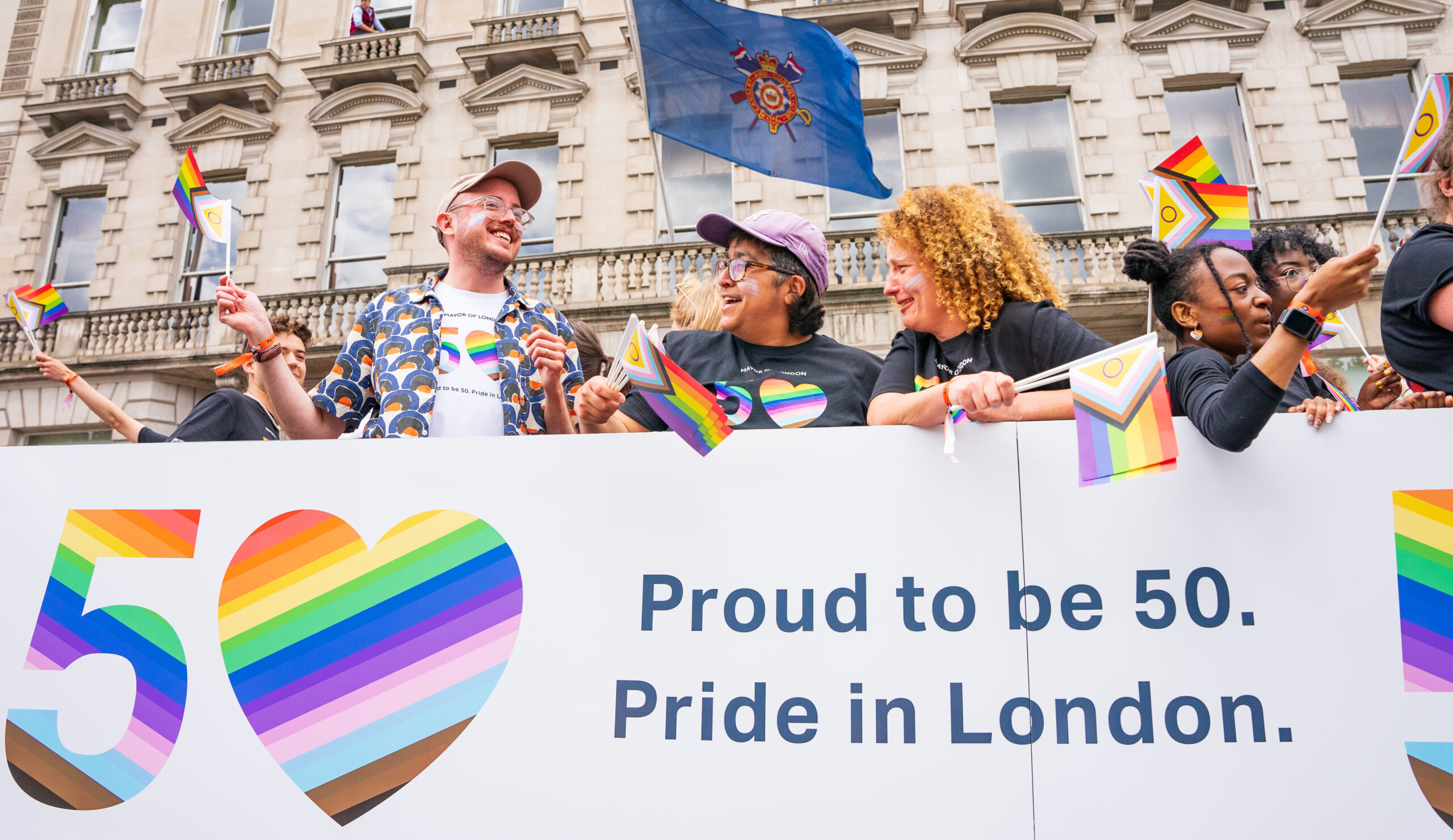 People waving flags at London Pride