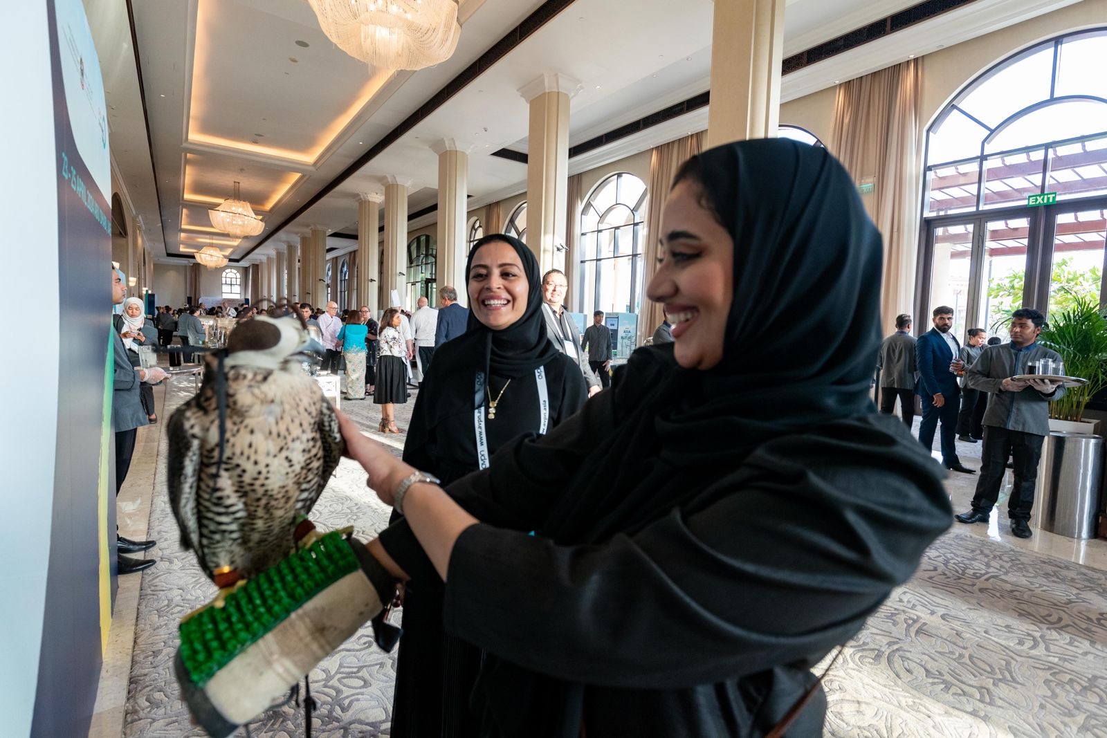 Woman holding a bird of prey at a Middle East event