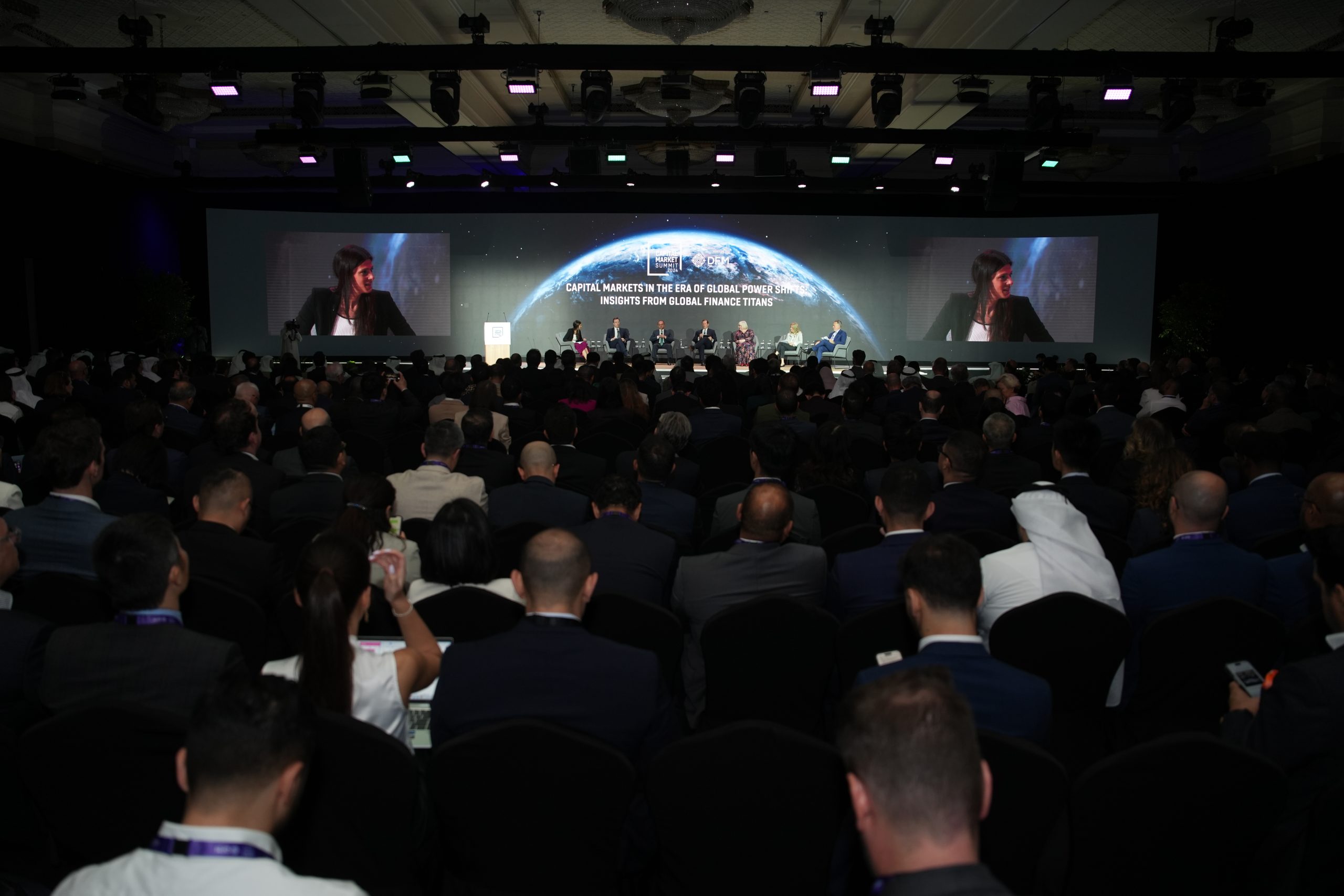 Audience facing a stage at a conference